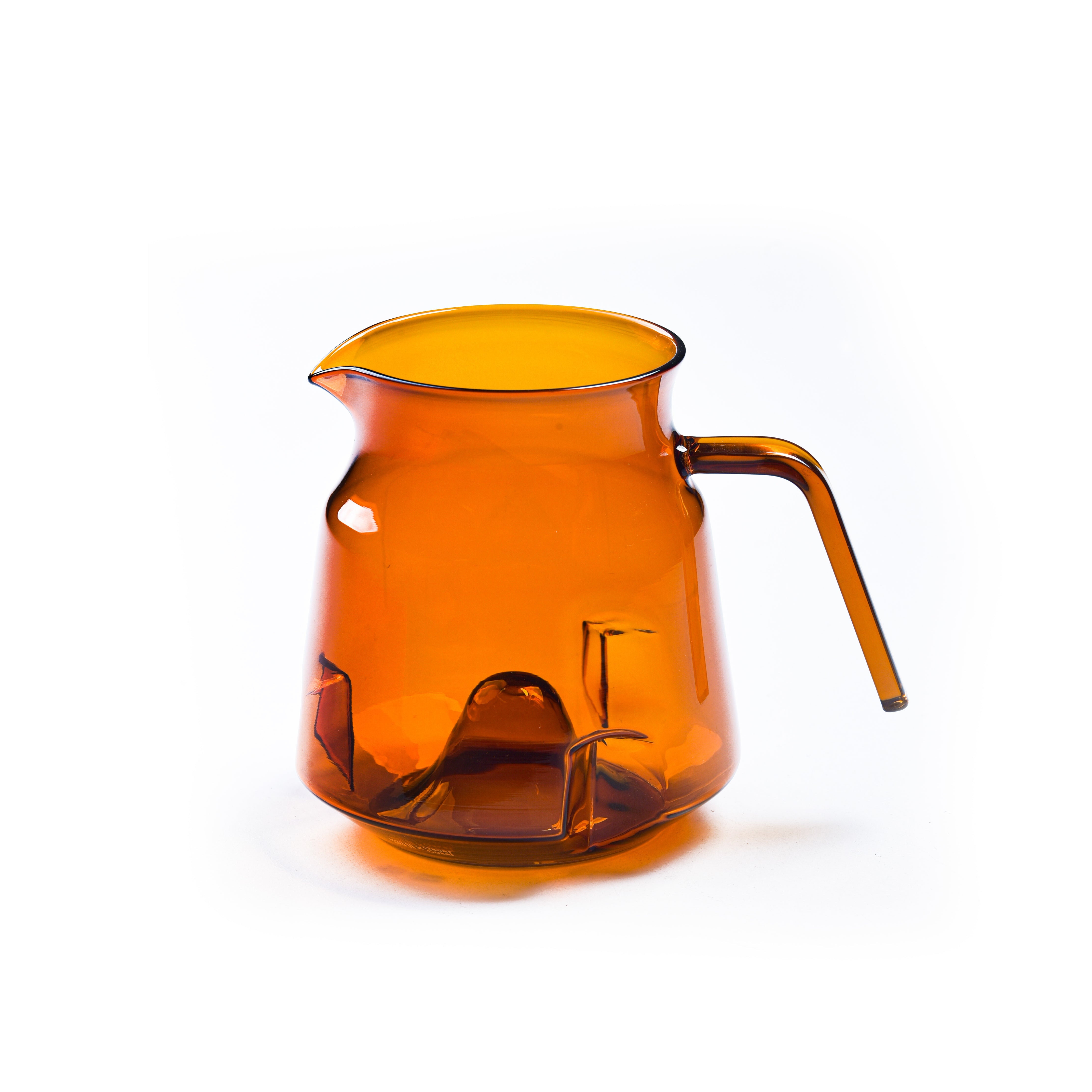 Orange glass pitcher on a white background with 'SUJI' branding.