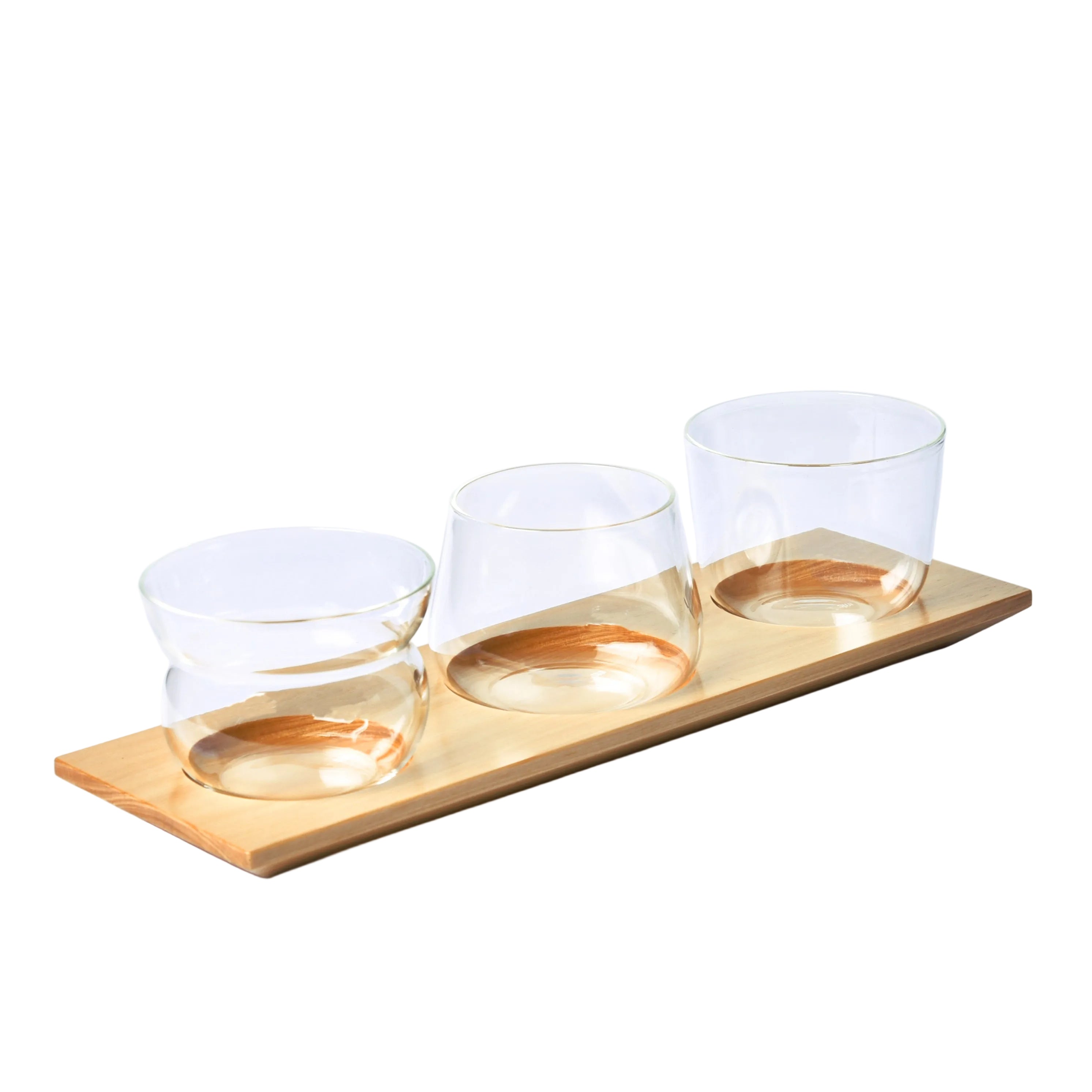 Three clear glass bowls on a wooden tray with 'SUJI' branding in the corner.